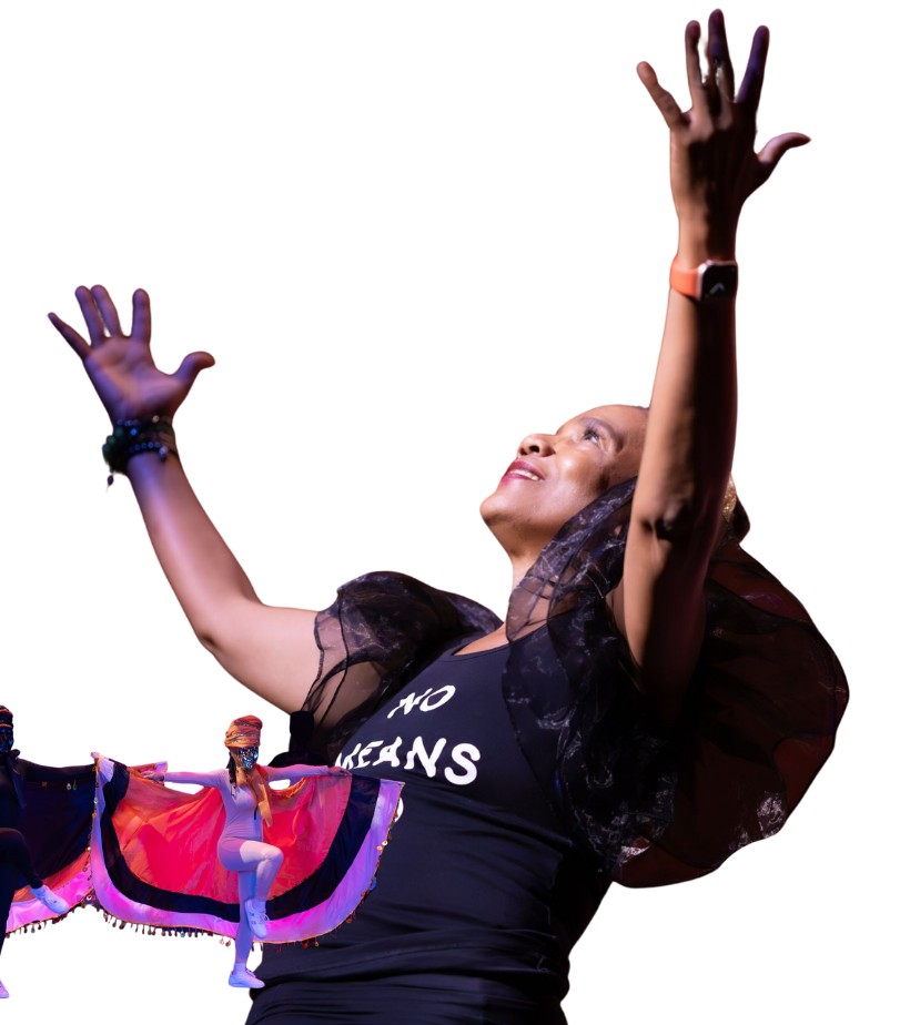 Performers from the Sistas Calling production on stage, arms raised mid-dance.